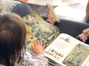 Little Girl Reading a Picture Book