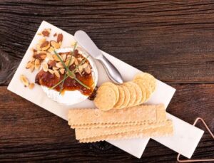 Baked Brie Topped with Fig Jam Alongside Crackers