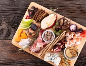 Cheese Board with Crackers, Prosciutto, Honey Butter, and More