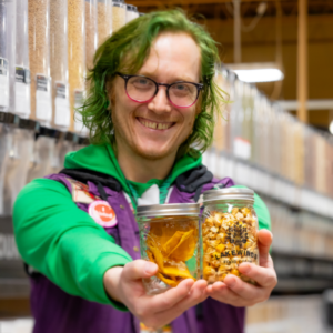 Employee Joker Holding Jars With Bulk Products